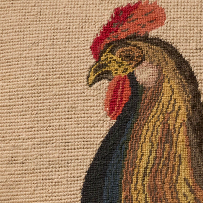 Beige woven rug with a stylized rooster motif in golds, browns and red on textured background.