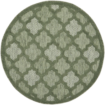 Round olive-green rug with a woven quatrefoil lattice pattern in lighter sage tones and a textured border.