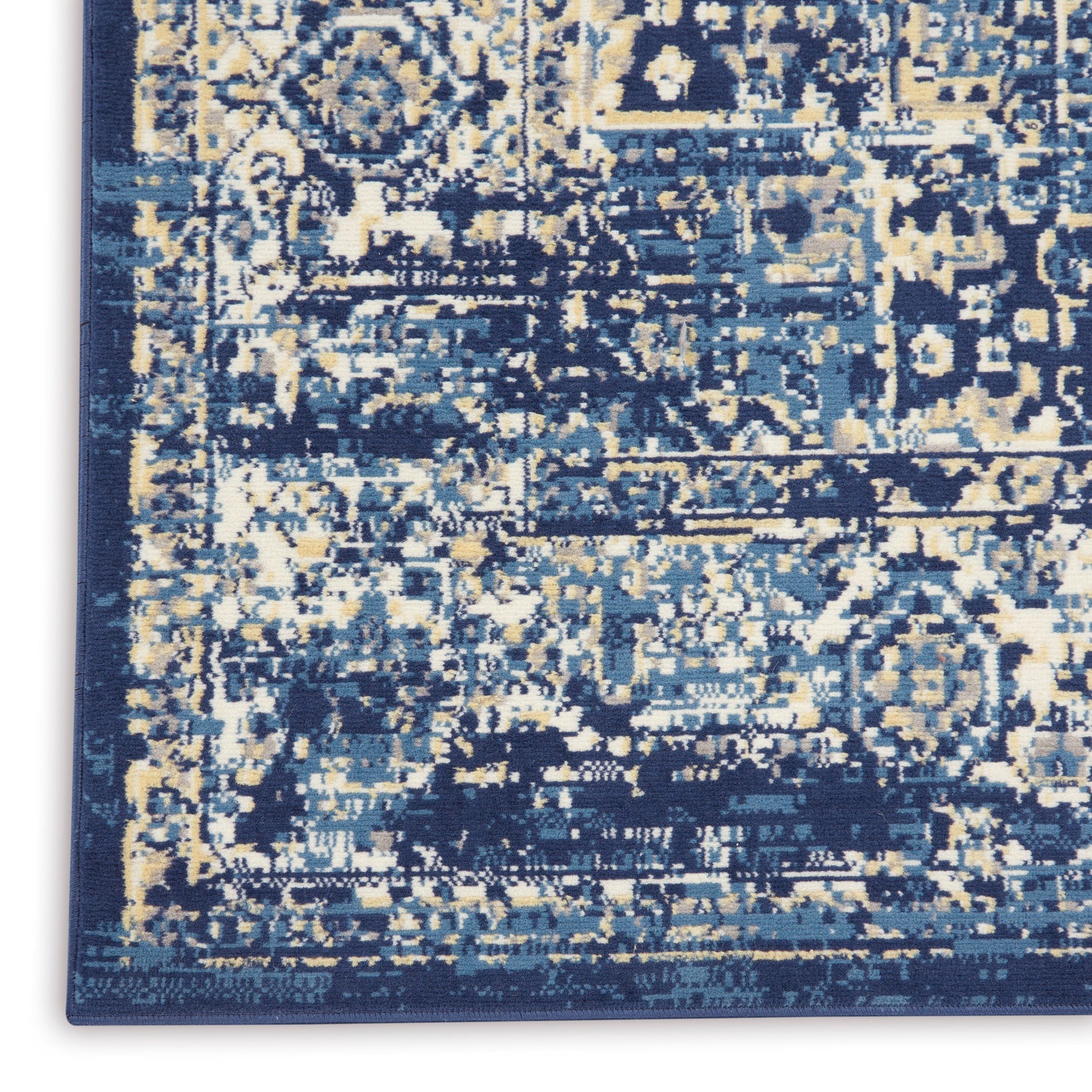 Distressed navy blue area rug with ivory and light blue abstract pattern; rectangular, plush woven floor covering.