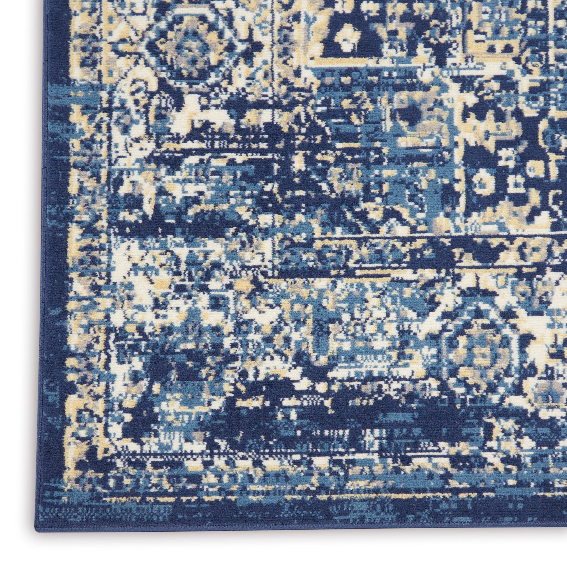 Distressed navy blue area rug with ivory and light blue abstract pattern; rectangular, plush woven floor covering.