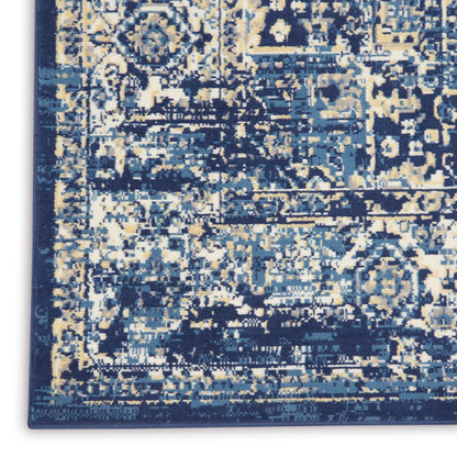 Distressed navy blue area rug with ivory and light blue abstract pattern; rectangular, plush woven floor covering.
