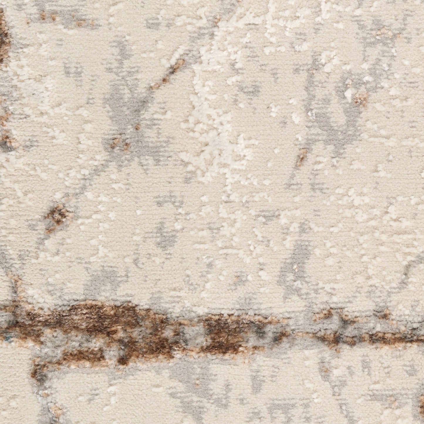 Beige abstract area rug close-up with soft cream pile, gray marbling and brown distressed stripe pattern.