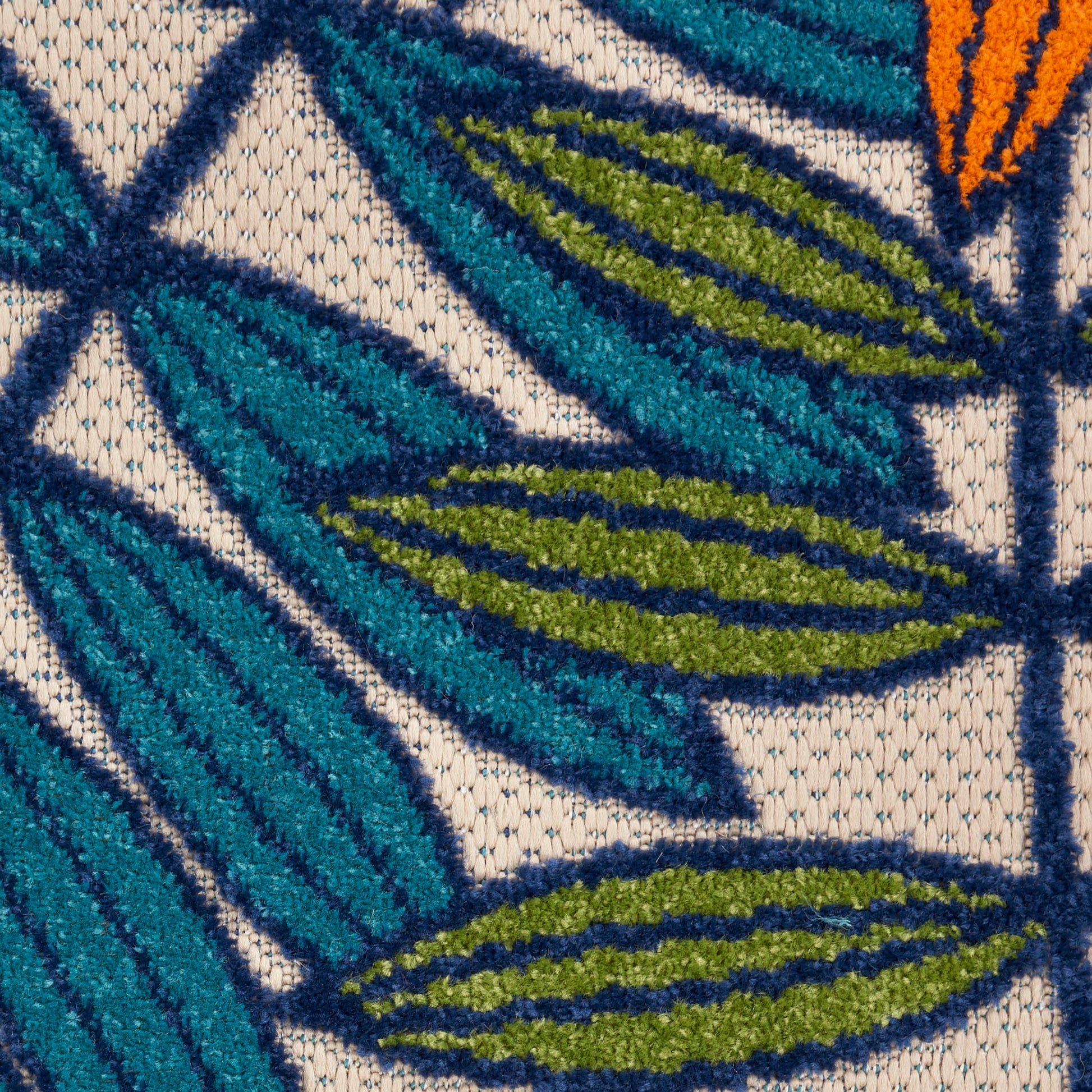 Close-up of teal and olive-green leaf pattern on beige textured fabric with dark navy outlines.