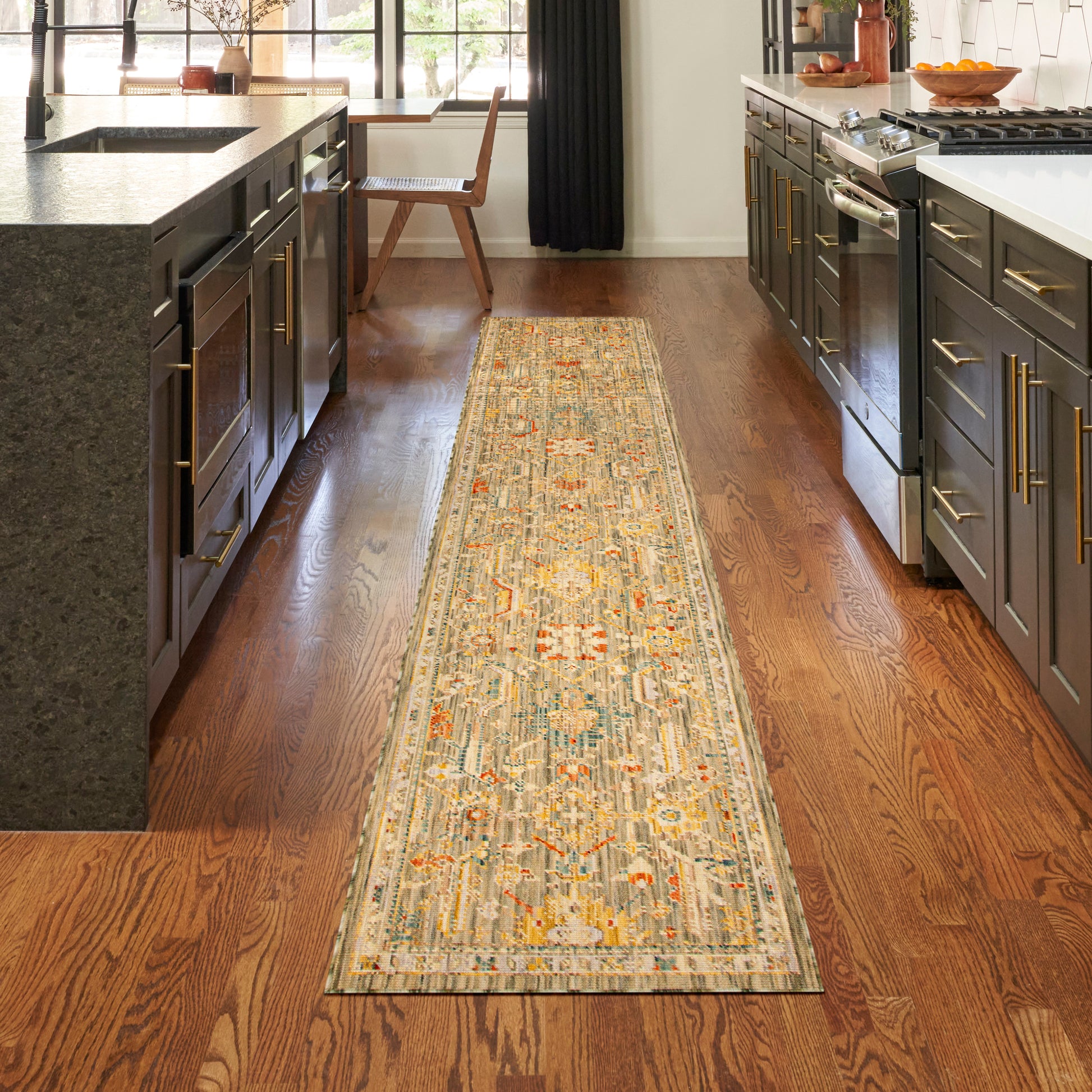 Long oriental-style runner rug with blue, ivory and orange patterns on a warm hardwood kitchen floor.