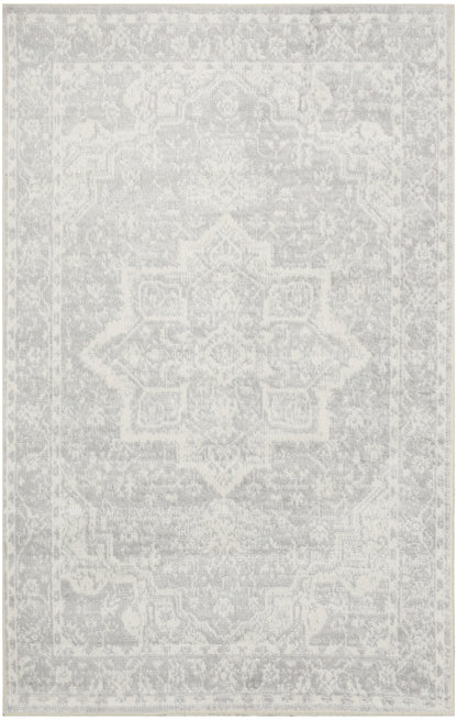 Rectangular light-gray distressed oriental rug with a faded central medallion pattern; versatile living room decor.