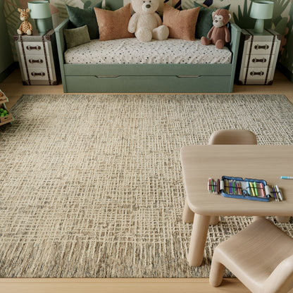 Beige textured rug in a child's room with a pastel green daybed with storage drawers, stuffed bears, a monkey, a polka-dot sheet, and a light wood activity table with colored pencils.
