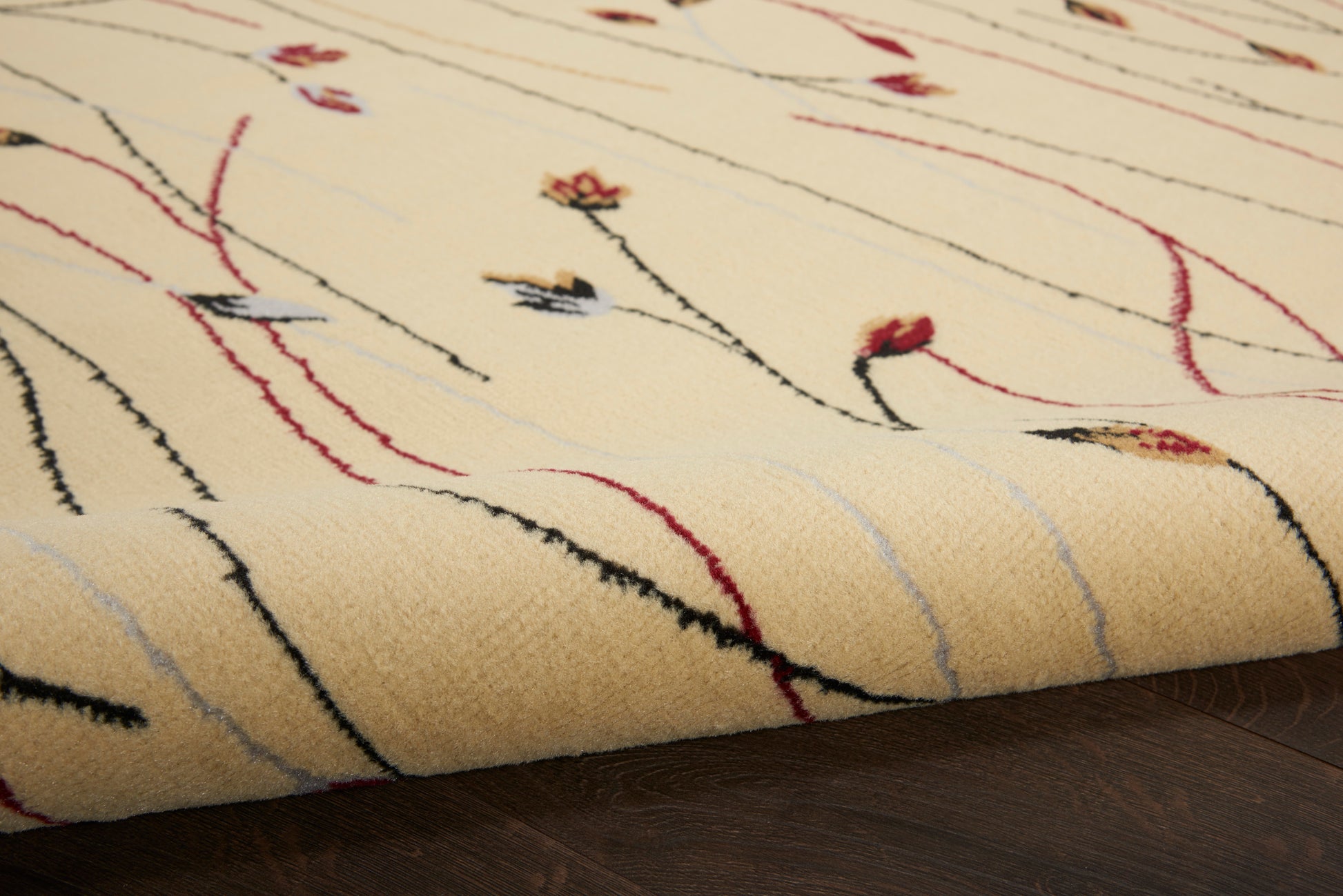 Cream wool rug with soft pile and abstract black, red, and pale-blue lines; rectangular living-room area rug.