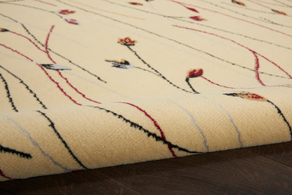 Cream wool rug with soft pile and abstract black, red, and pale-blue lines; rectangular living-room area rug.