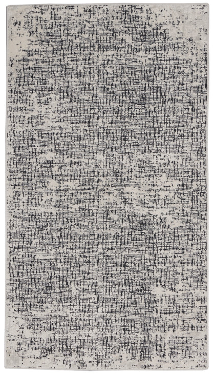 Rectangular cream rug with a black abstract distressed pattern, modern area rug for living rooms.