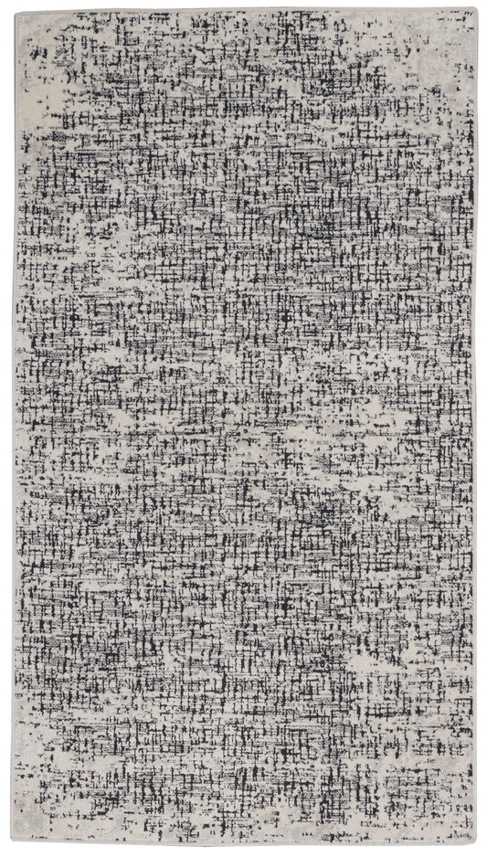 Rectangular cream rug with a black abstract distressed pattern, modern area rug for living rooms.