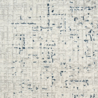 Cream ivory abstract runner rug with navy blue specks and linear distressed pattern, woven texture.