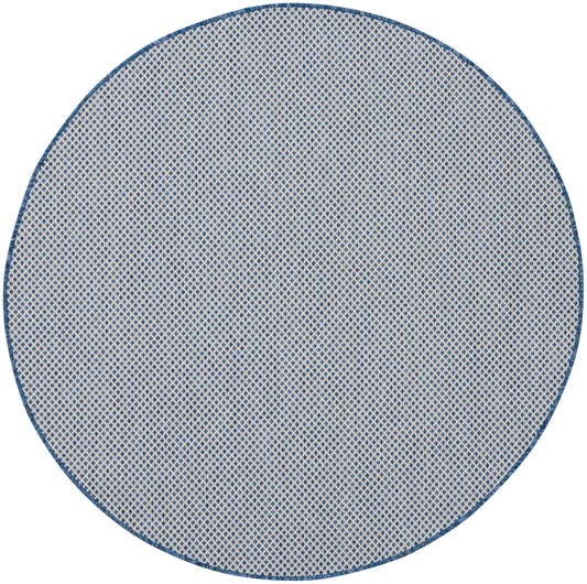 5' round rug with blue border and cream woven lattice texture.