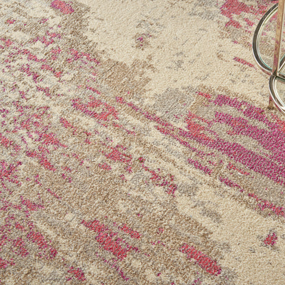 Beige area rug with pink abstract pattern and plush texture; metal circular ring in the top-right corner.