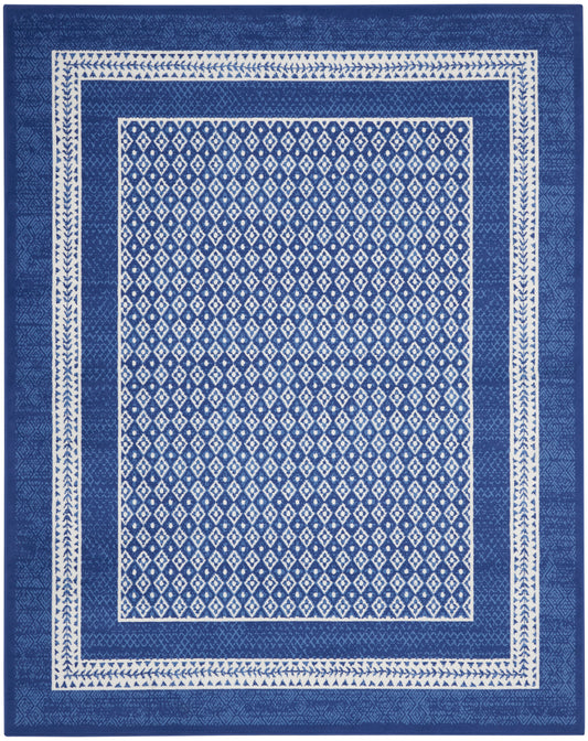 Blue rectangular area rug with white diamond lattice center and white geometric borders.