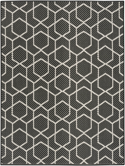 Black area rug with white interconnected hexagon lattice pattern for modern geometric decor.