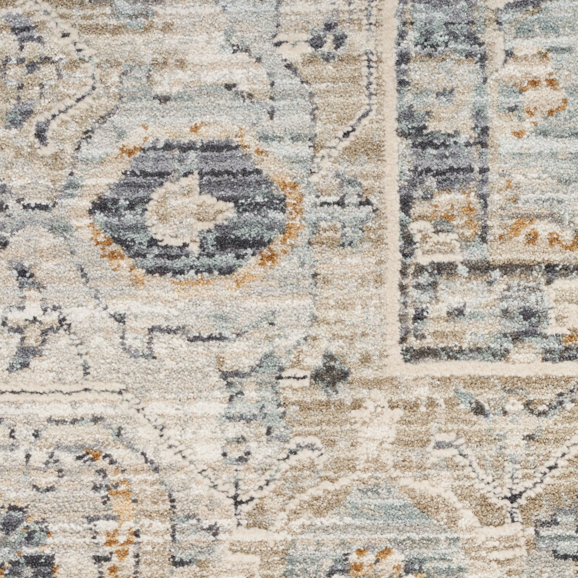 Beige, blue and gray Persian-inspired rug close-up with medallion and floral motifs in a soft, textured pile.