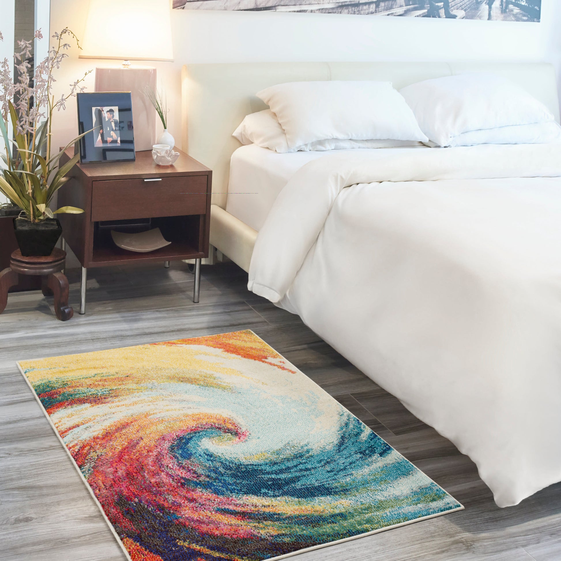 Modern 3' x 5' rug with a vibrant multicolor swirl pattern on grey wood flooring