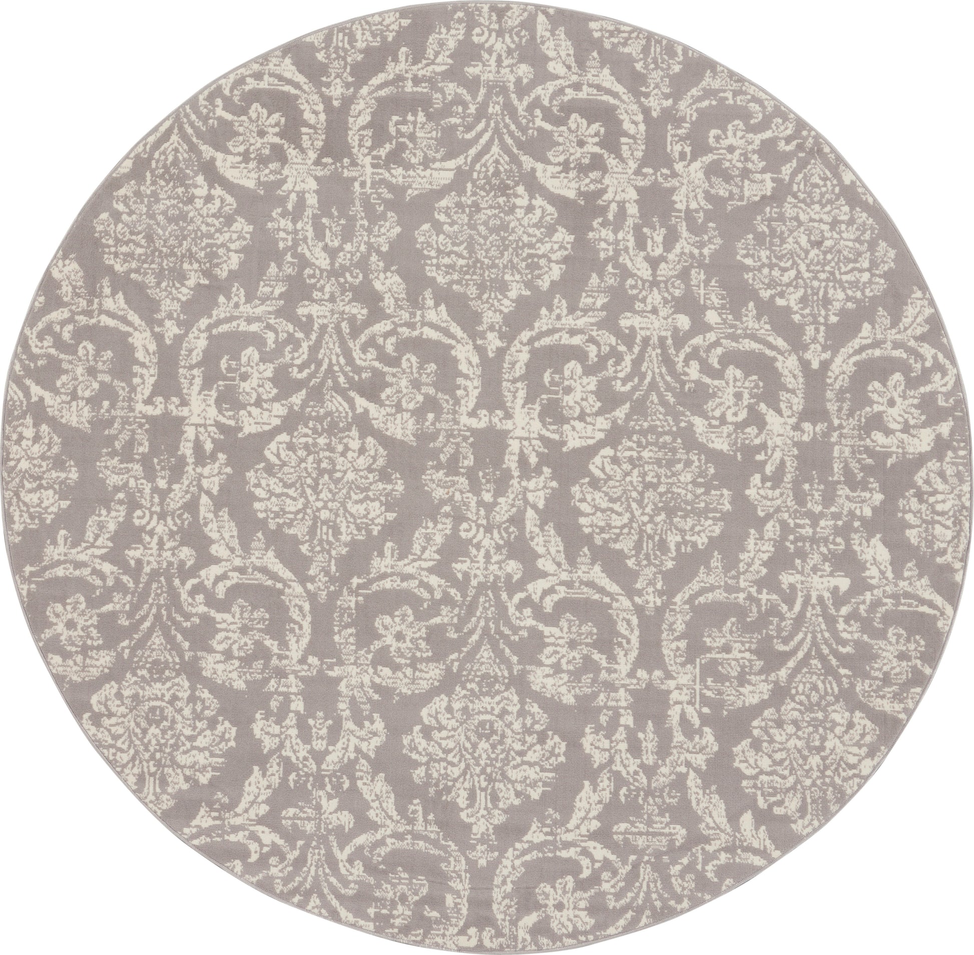 Round rug in muted gray-lavender with ivory damask pattern