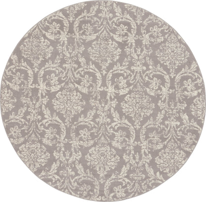Round rug in muted gray-lavender with ivory damask pattern