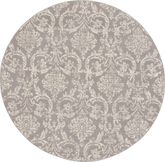 Round rug in muted gray-lavender with ivory damask pattern