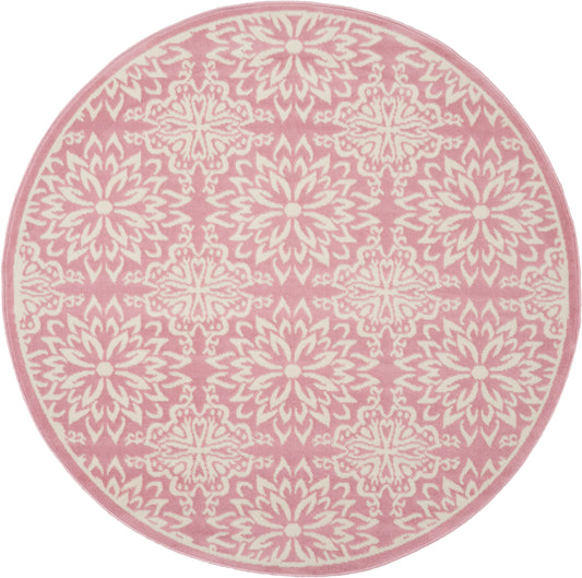 Round pink rug with white mandala floral pattern and pink border.