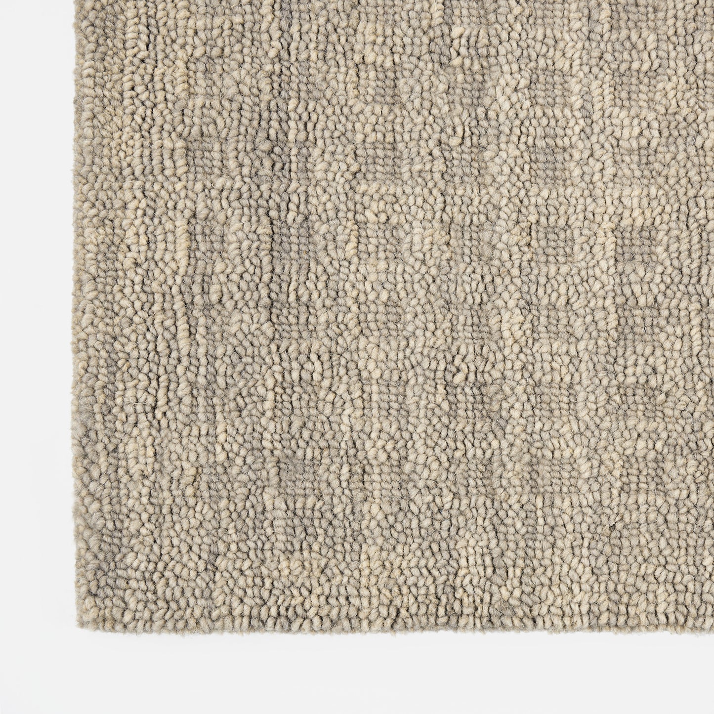 Beige-gray boucle rug with dense loop pile; soft, textured floor covering for living rooms.