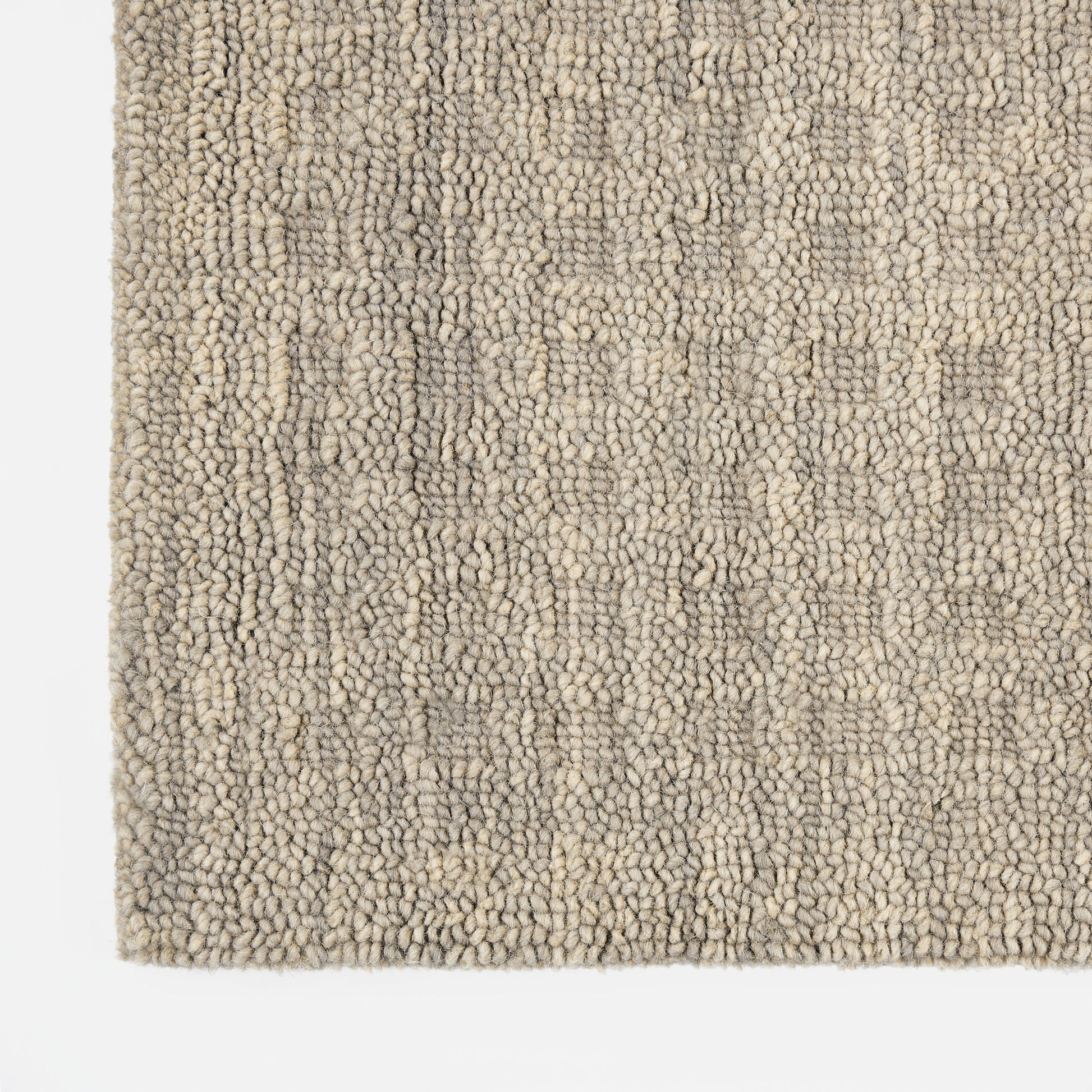 Beige-gray boucle rug with dense loop pile; soft, textured floor covering for living rooms.