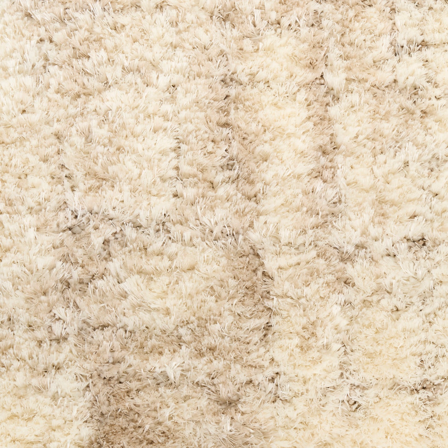 Beige shag rug with long plush pile in creamy tones, soft and cozy for living room decor.
