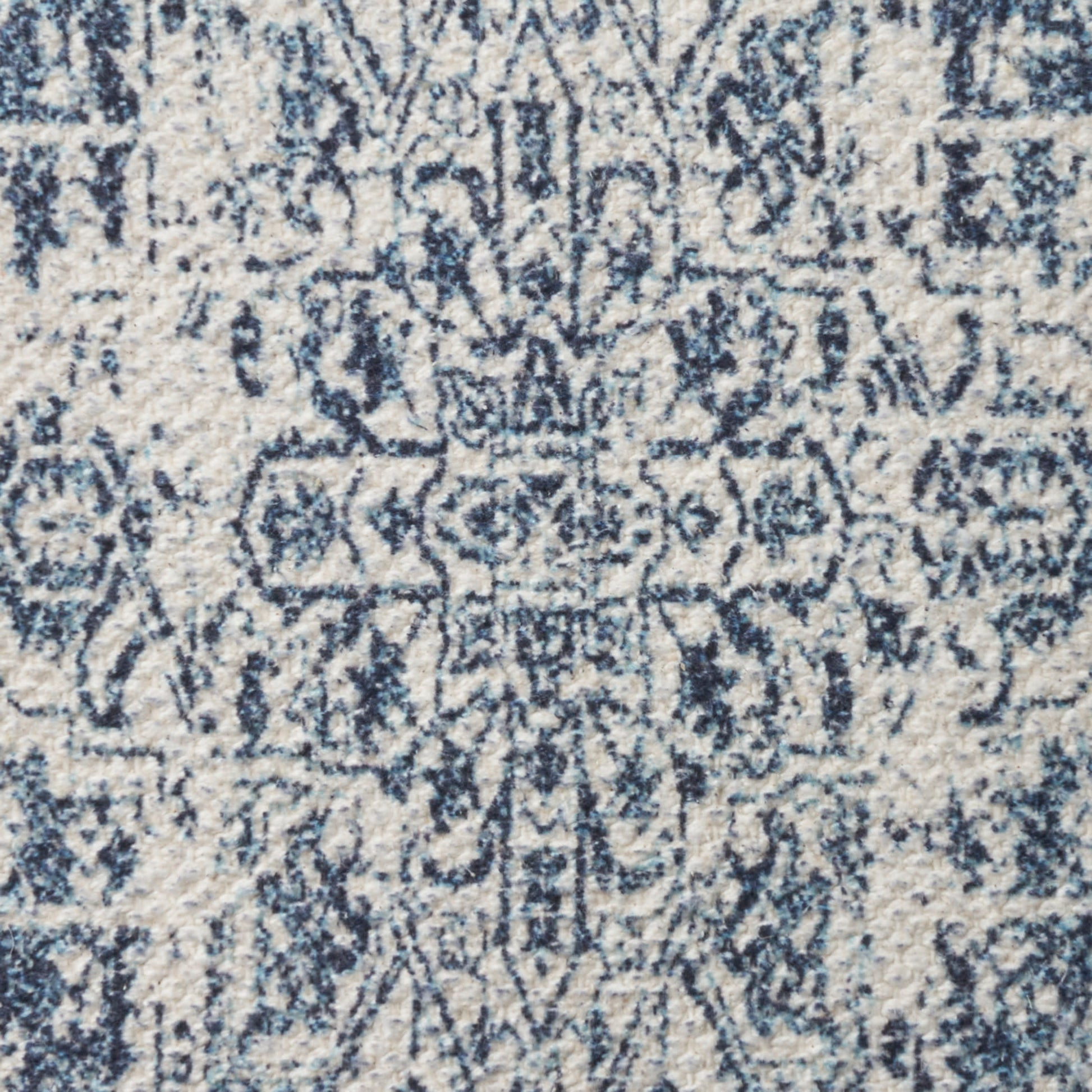 Blue & ivory area rug with distressed geometric medallion pattern and ornate border.