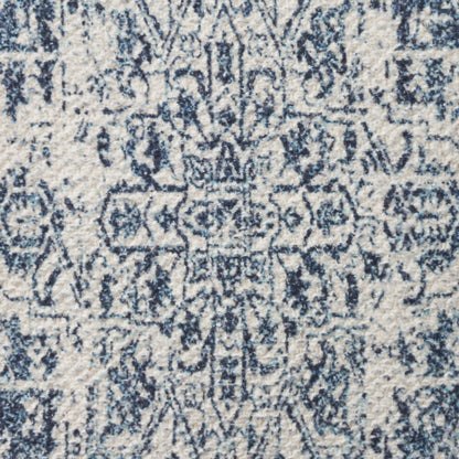 Blue & ivory area rug with distressed geometric medallion pattern and ornate border.