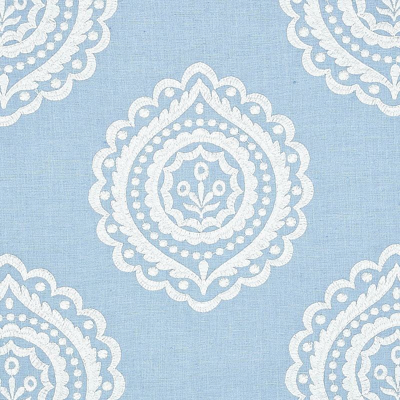 Light blue linen embroidery fabric with repeating white damask-style medallion motifs.