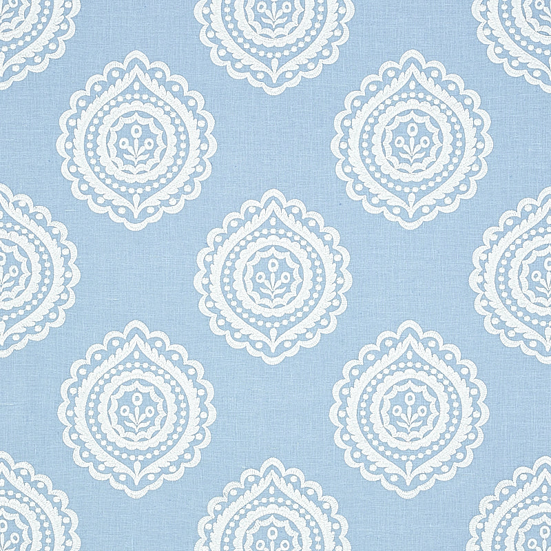 Light blue linen embroidery fabric with white embroidered medallions in a seamless damask-inspired pattern suitable for curtains or upholstery.