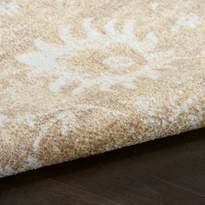 Beige area rug with cream floral pattern, soft plush pile, edge folded on dark wood floor.