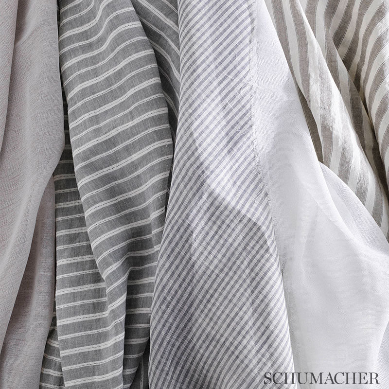 Assorted striped sheers in gray, white, and taupe tones, draped in soft folds.
