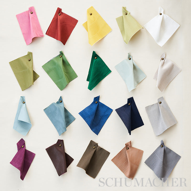 Grid of fabric swatches in pink, red, yellow, green, blue & neutral tones with metal grommets.