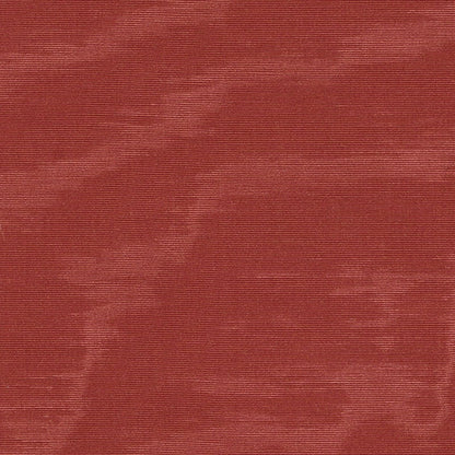 Moire fabric close-up in cinnabar red with a wavy pattern.