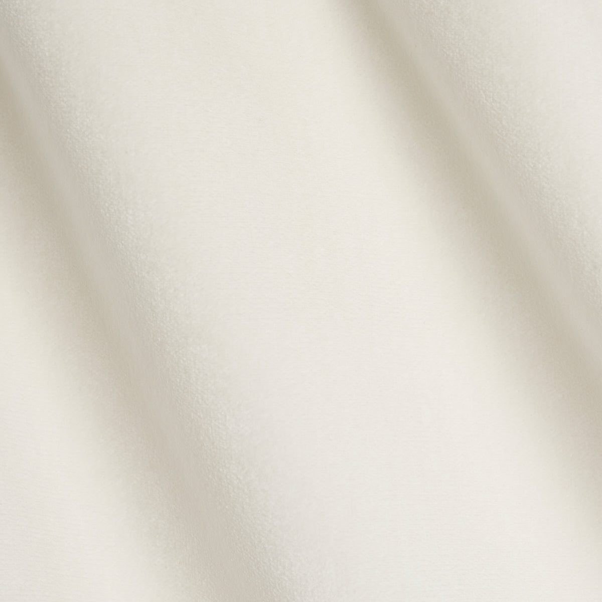 Ivory velvet fabric with soft folds and subtle sheen, luxurious draped material for garments.
