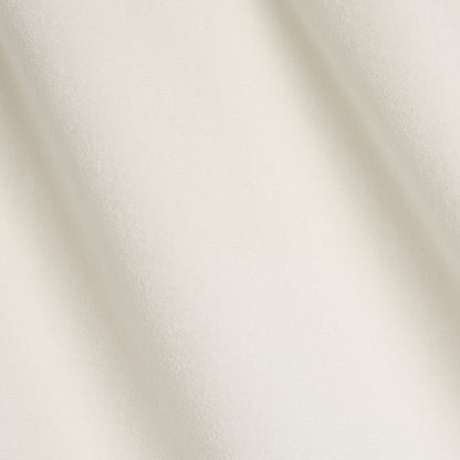 Ivory velvet fabric with soft folds and subtle sheen, luxurious draped material for garments.