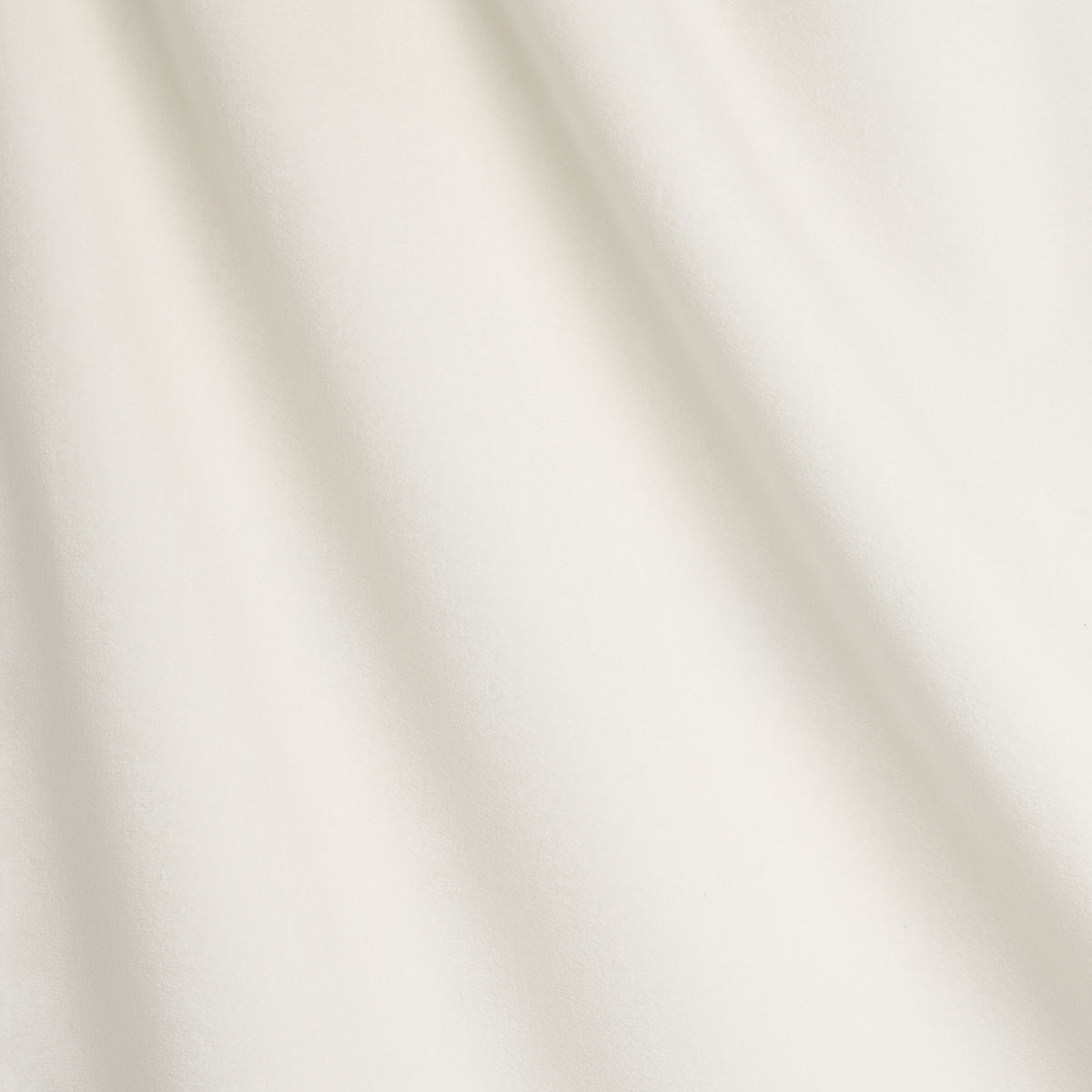Cream draped fabric with soft diagonal folds and a smooth matte finish.
