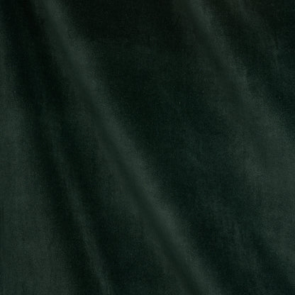 Dark forest green velvet fabric close-up with soft diagonal drape.