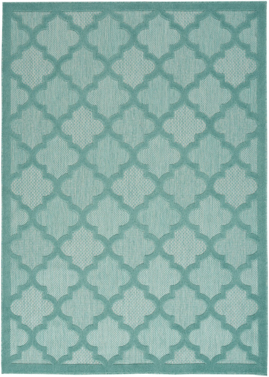 Turquoise rug with lighter teal quatrefoil trellis pattern and woven texture.