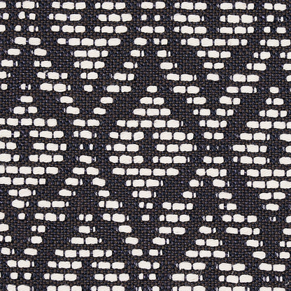 Charcoal upholstery fabric with a small-scale red hook pattern, woven texture.