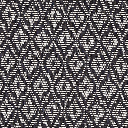 Black fabric with cream diamond lattice pattern; woven geometric textile for upholstery or apparel.