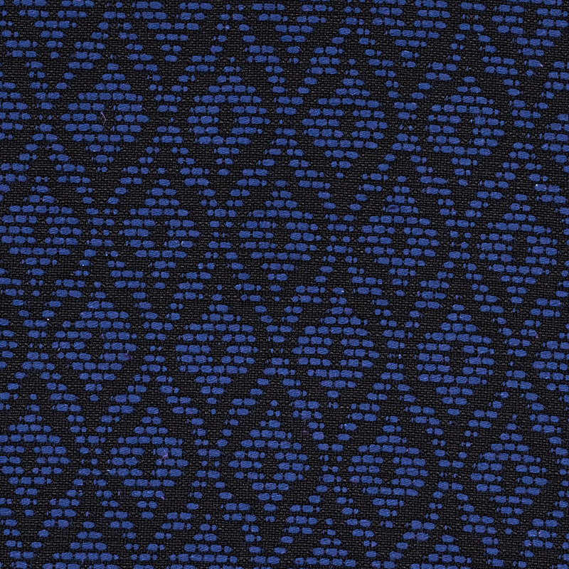 Navy blue fabric with a repeating diamond pattern made of small blue dots; woven texture.