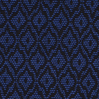 Navy blue fabric with a repeating diamond pattern made of small blue dots; woven texture.