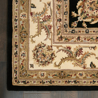 Persian-style oriental rug, cream base, black central field, gold and pink florals, ornate bordered frames; wool.