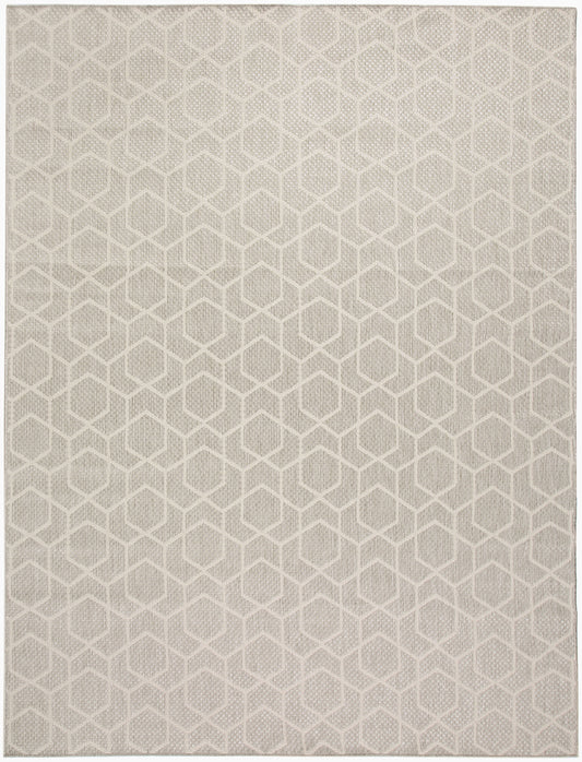 Beige woven rug with a repeating cream hexagonal geometric pattern.