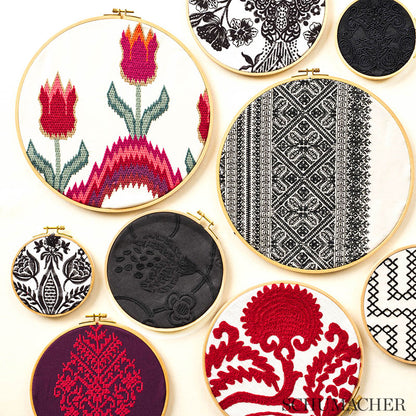 Assorted embroidery fabrics with colorful patterns: florals, black-and-white geometric, red tree, and a purple motif.