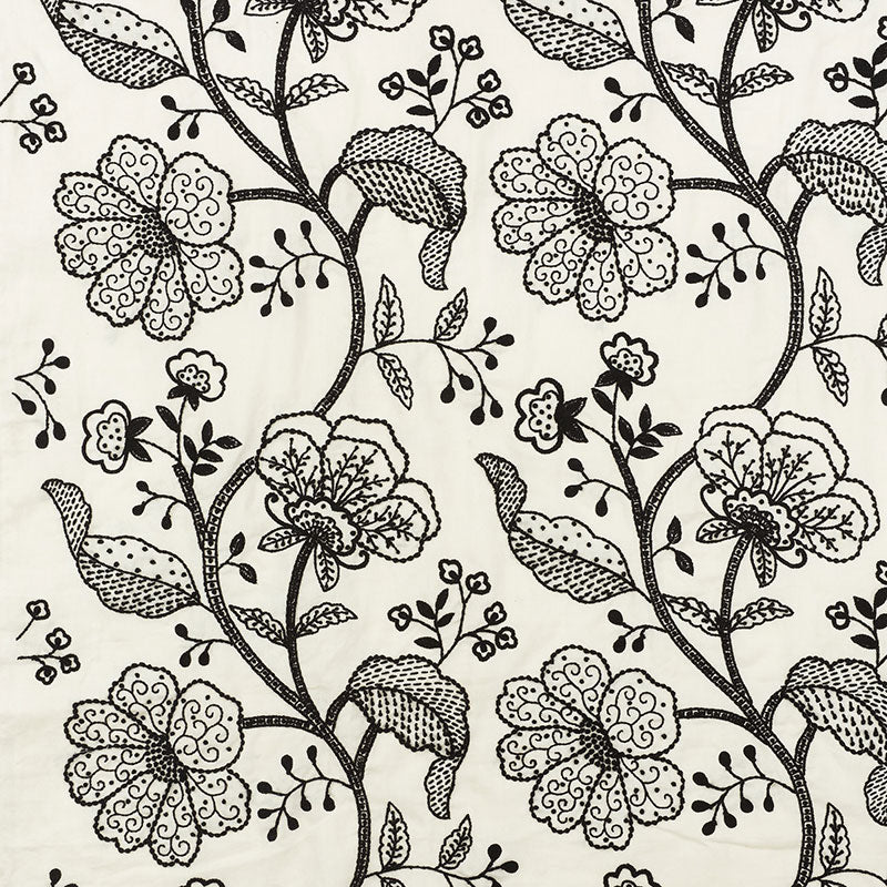 Cream fabric with an intricate black floral pattern of twisting vines and large blossoms.