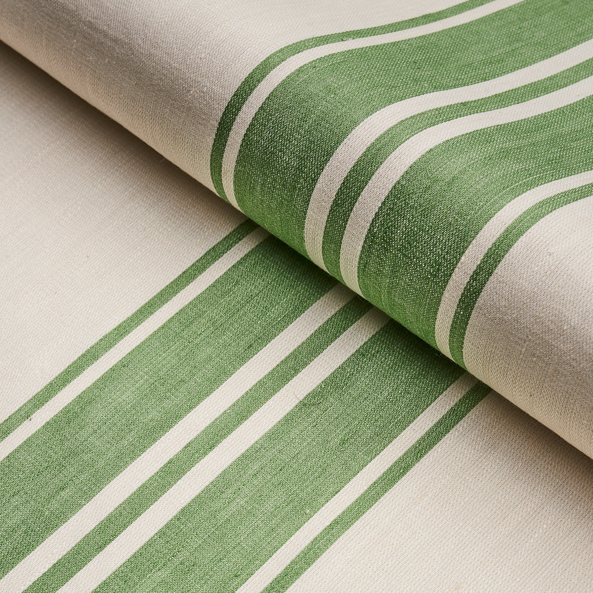 Beige woven fabric with leaf-green striped bands and white borders, rolled textile.